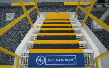 Step Covers with printed informative text on ship decks. Anti-slip stair step covers on steel surface